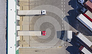 Trailers at docking stations of a distribution center waiting to be loaded