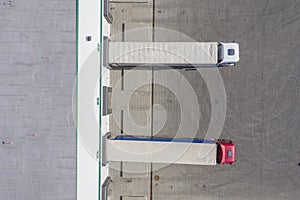 Trailers at docking stations of a distribution center waiting to be loaded