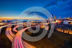 Trailing Car Lights and the Seattle Skyline at Sunset