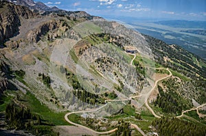 Trails and dirt roads through the Grand Tetons mountains in Jackson Hole Wyoming during the summer. Aerial view