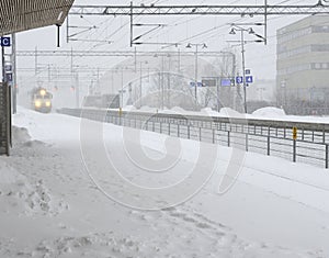 the train arrives at the station during a blizzard photo