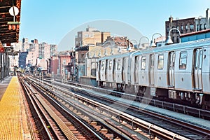 Train arriving at the station in New York City. Buildings in the background, cityscape. Travel and transit concept. Manhattan, NYC