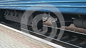 Train Arriving In Station Platform. Transport and logistic background. Close-up of the wheels
