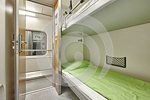 Train berth corridor indoor with two beds. Travel background.