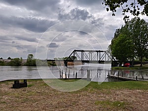 Train bridge Fishing village Boats marina View Water sky clouds lake sea