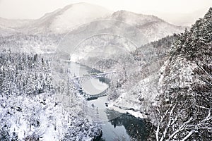 Train on the bridge over Tadami river in Japan