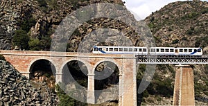 Train on the bridge through a precipice, Corsica photo