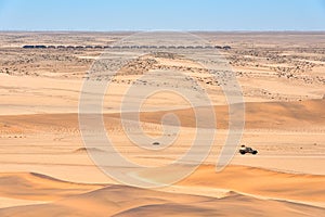 Train and car in the desert in Namibia