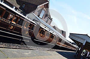 Train carriages stationary at station platform.