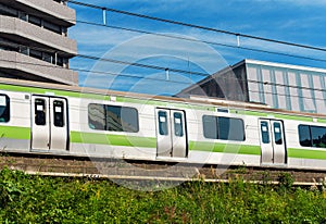 Train on the city`s city street, Tokyo, Japan. Copy space for text.