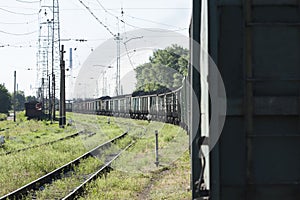 Train with coking coal cars on the background of the coke plant.