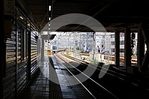 Train coming when people waiting for transportation