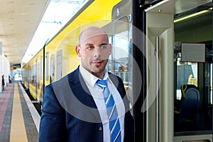 The train conductor on the platform next to the train