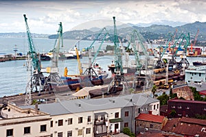 train, cranes, and ship in harbour depot yard in Batumi