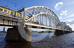 Train Crosses the Iron Bridge over the Daugava River in Riga