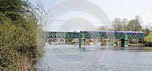 Train crossing bridge over Thames at Bourne End photo