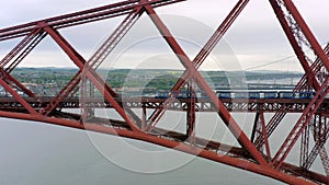 A Train Crossing a Red Bridge in Scotland