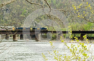 Train crossing river bridge