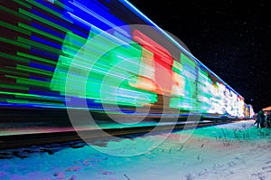 Train Decorated with Holiday Lights Arrives at Station