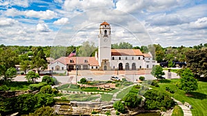 Train depot aerial view with American Flag and clouds in the sky