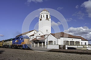 Train depot and engine passing by