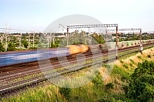 Train with different freight cars that are blurred at high speed