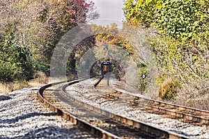 A train disappearing in the distance in an autumn landscape photo