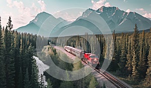 a train driving along tracks in canadian forest with mountains in foreground