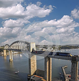 Train going from Cornwall on Royal Albert Bridge designed by Brunel in Plymouth, Devon, England, UK