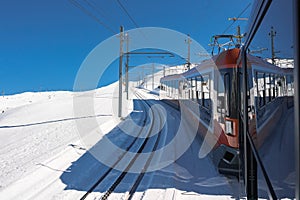 The train of Gonergratbahn running to the Gornergrat station and Stellarium Observatory