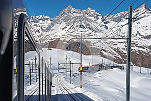 The train of Gonergratbahn running to the Gornergrat station and Stellarium Observatory