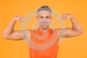 Train hard be strong. Strong man flex arms yellow background. Building strong biceps and triceps. Happy athlete show