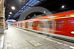 Train im motion in an old station