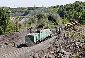 Train at the iron ore opencast mine is going for loading