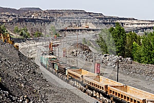 Train at the iron ore opencast mine is going for loading