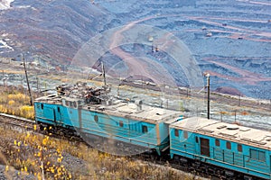 Train at the iron ore opencast mine is going for loading iron