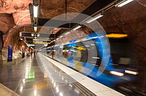 Train leaving Radhuset metro station photo