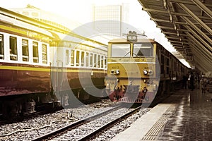 Train led by Old yellow Diesel Electric locomotives at Bangkok Railway Station