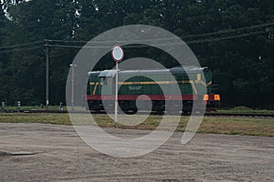 Train locomotive rides on rails. Diesel freight train on railroad in motion. The head of a heavy diesel tractor