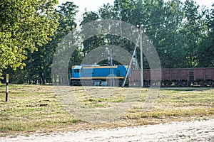 Train locomotive rides on rails. Diesel freight train on railroad in motion. The head of a heavy diesel tractor