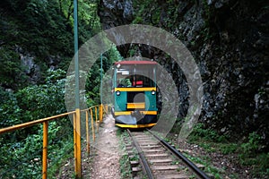 Train in mountains. Railway among rocks. Travelling background.