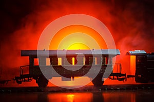 Train moving in fog. Ancient steam locomotive in night. Night train moving on railroad. orange fire background.