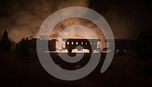 Train moving in fog. Ancient steam locomotive in night. Night train moving on railroad. toned foggy fire background. Horror mystic