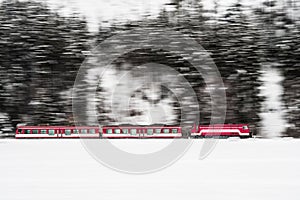 Train moving in winter landscape with snow