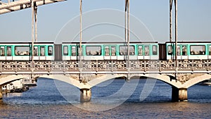 Train of Parisian subway (line 5) passing on Austerlitz viaduct over the river Seine in Paris