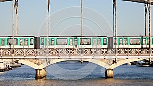 Train of Parisian subway (line 5) passing on Austerlitz viaduct over the river Seine in Paris