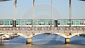 Train of Parisian subway (line 5) passing on Austerlitz viaduct over the river Seine in Paris