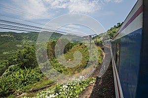 Train passes hills and jungle at the Hai Van Pass between Hue and Da Nang in Central Vietnam