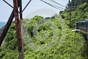 Train passes the sea, the hills, and jungle at the Hai Van Pass between Hue and Da Nang in Central Vietnam