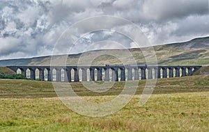 Train passing over Ribblehead Viaduct. North Yorkshire, England.